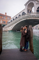 Couple kissing near the water in Venice after their proposal.