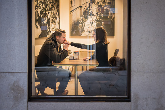 Couple raising their coffee cups in celebration at a Venice café.
