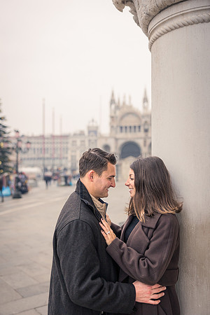 Couple kissing near St. Mark’s Square, celebrating their engagement.