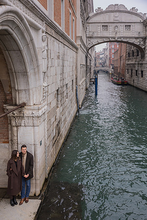 Couple posing near the Bridge of Sighs in Venice.
