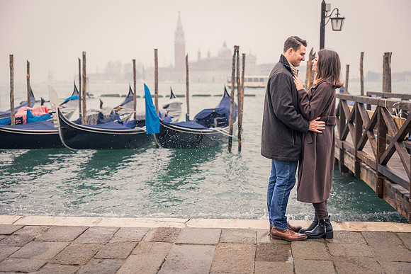Couple sitting in a gondola, enjoying a romantic moment after their proposal.