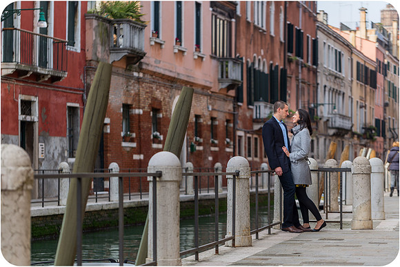 A couple walking through a narrow Venetian alley in winter