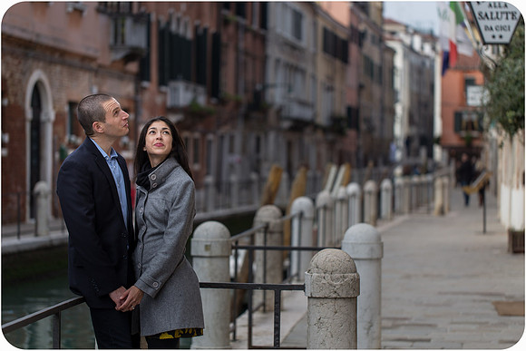 Couple posing on a bridge over a canal in winter Venice