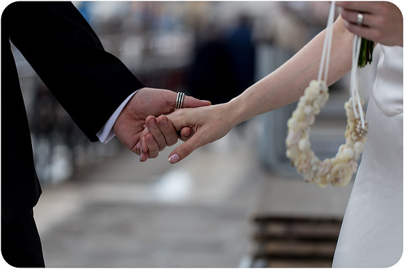 Wedding couple walking hand in hand along Venice.