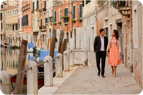 Couple walking through a narrow Venetian street