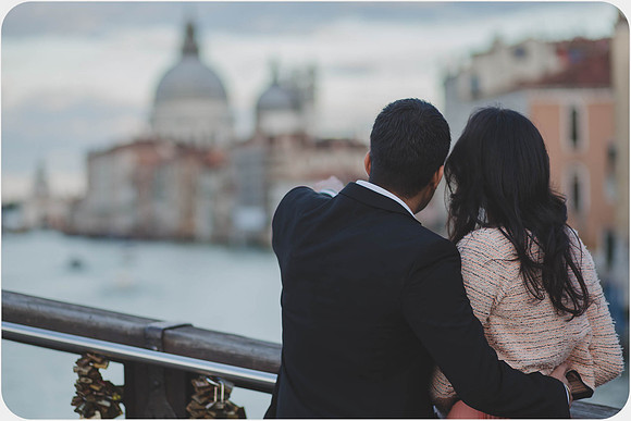Couple standing by a Venetian railing at sunset