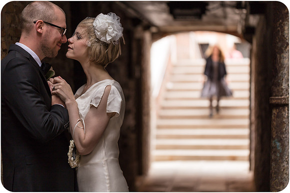 Couple seated during wedding ceremony at Palazzo Cavalli