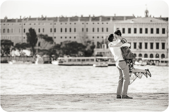 A couple shares a romantic moment after saying yes in Venice.