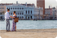 A joyful embrace following a proposal on the Venetian waterfront.