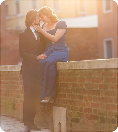 The bride-to-be softly places her hand on her fiancé’s shoulder, cherishing the moment.