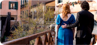 The couple stands on the bridge, admiring the beauty of their new beginning.