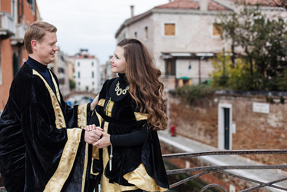 Venetian carnival couple in elegant attire sharing a moment.