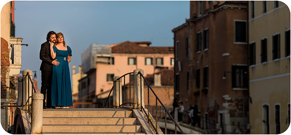A warm and passionate kiss as the sun sets over Venice.