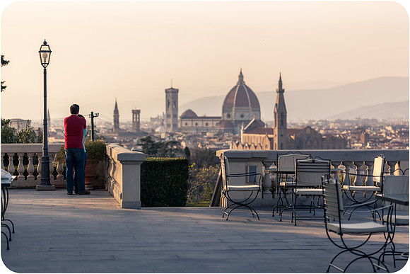 Couple viewing Florence’s Duomo from terrace.