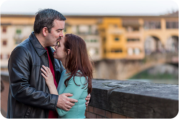 Couple sharing moment by Florence's riverside.