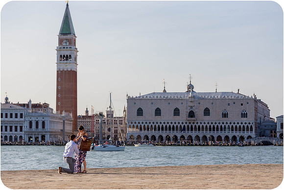 A couple embraces after an emotional engagement moment in the floating city.