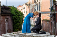 The bride-to-be bends down in happiness as she accepts the surprise proposal.