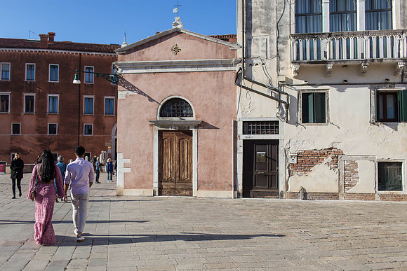 Couple arriving at historic church in Dorsoduro for a proposal.