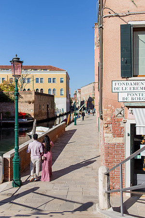 Couple walking near canals in Dorsoduro, Venice.