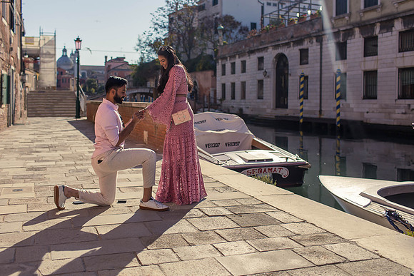 Couple holding hands walking by the canal in Dorsoduro, Venice.