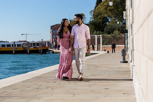 Couple walking along the Grand Canal in Dorsoduro, Venice.
