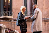 A newly engaged couple looks into each other's eyes with joy after a surprise proposal.