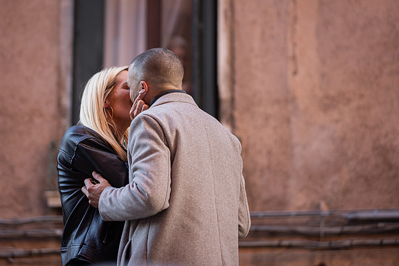 The couple shares their first kiss after getting engaged on a beautiful Venetian bridge.