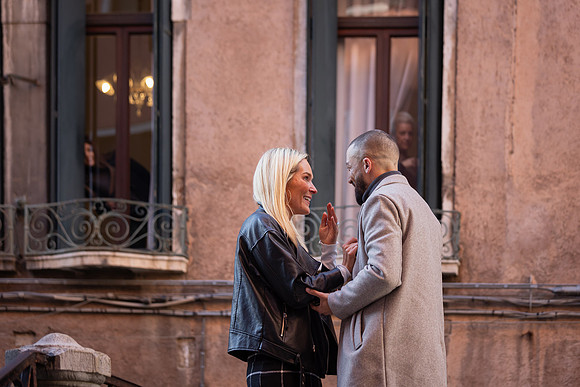 A touching moment as the couple holds hands and promises a lifetime together.