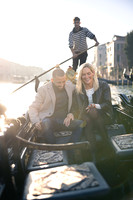 A couple enjoys a romantic gondola ride after a surprise engagement in Venice.