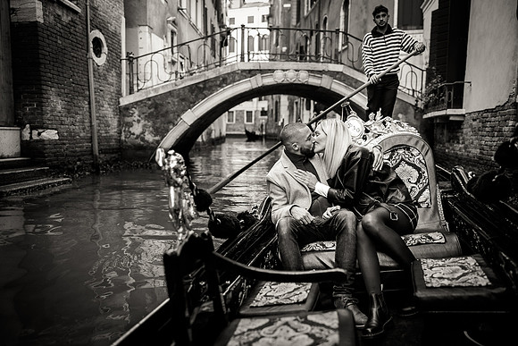 A moment of passion as the couple shares a romantic embrace in a gondola.