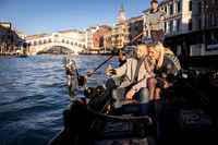 A couple enjoys the stunning Grand Canal views after their engagement.