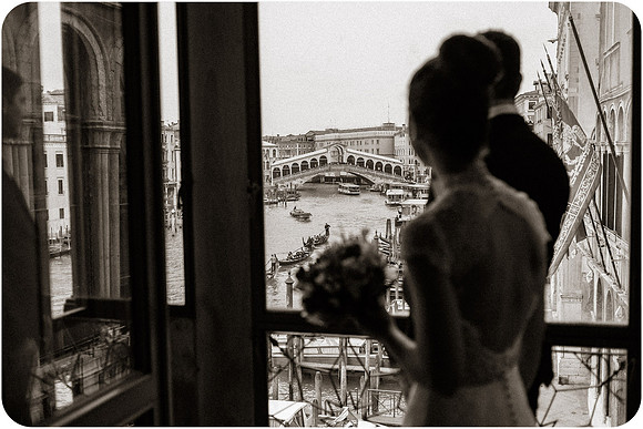 Bride holding bouquet by window