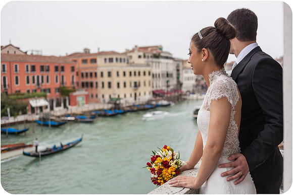 Bride and groom walking along Venice waterfront