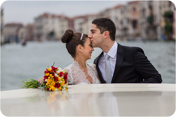 Bride and groom on water taxi with flowers