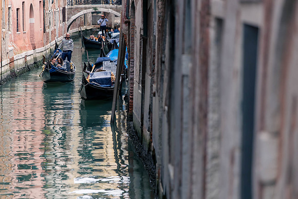 Couple in gondola under Venetian bridge