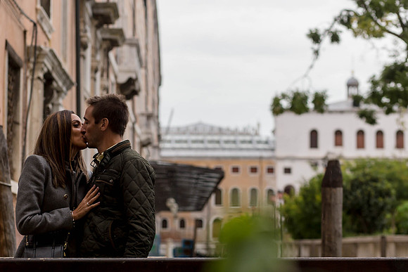 Couple sitting by Venice waterfront