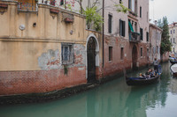 Venetian canal with gondola in motion