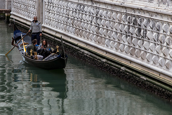 Gondola passing under Venetian bridge