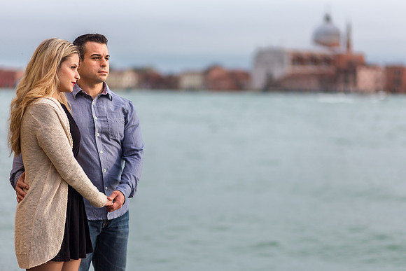 Couple walking beside a canal in Venice