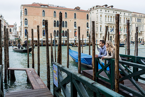 Couple near the water and gondolas in Venice