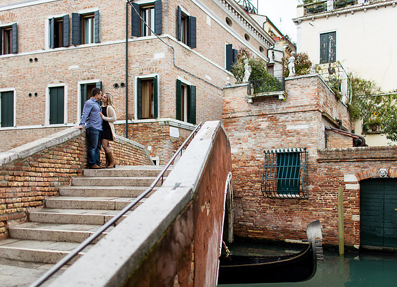 Couple standing near the water in Venice during an engagement shoot