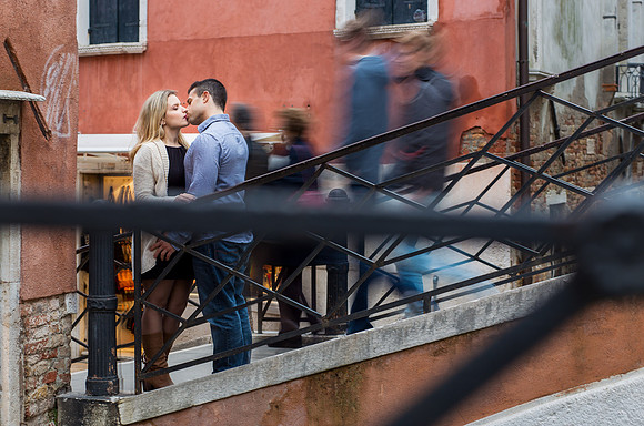 Couple walking through a lively street in Venice