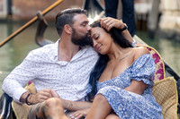 Couple embracing on gondola ride through Venice canals
