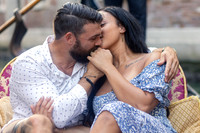 Candid moment of couple on gondola after Venice proposal