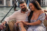 Newly engaged couple on gondola in Venice