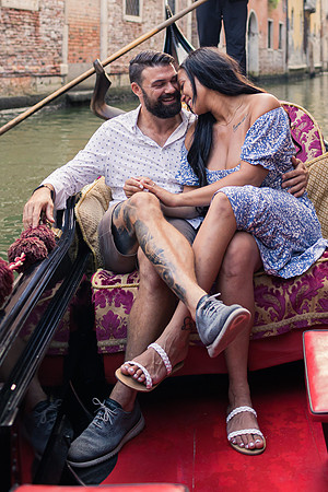 Couple embracing on gondola ride in Venice