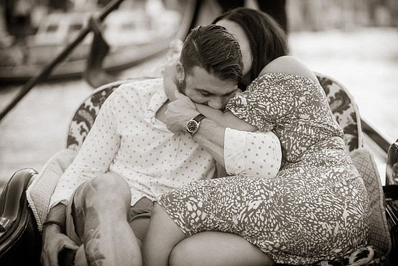 Candid embrace on gondola ride through Venice