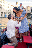 Fiancé kneeling during gondola proposal in Venice