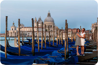 Mother and daughter walking by the gondolas in Venice during a peaceful morning.