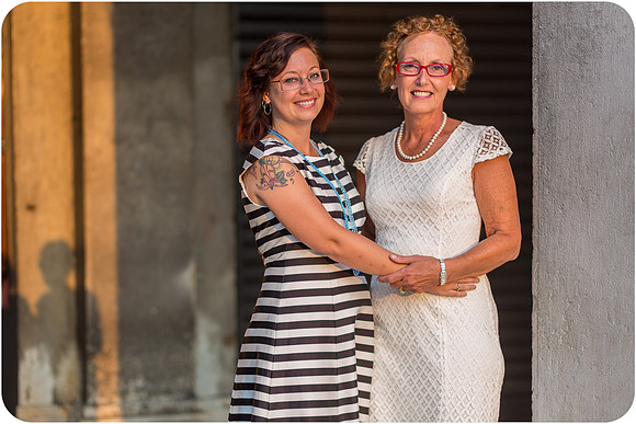 Mother and daughter walking through St. Mark's Square, bathed in golden morning light.